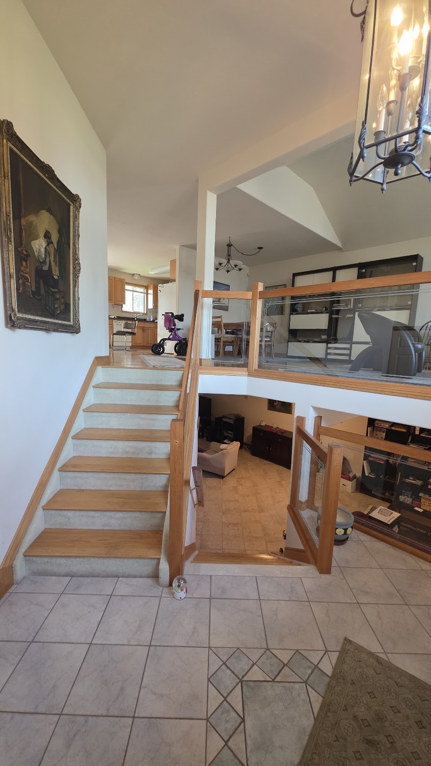 Main staircase — split-level layout connecting the lower living area to the upper floor